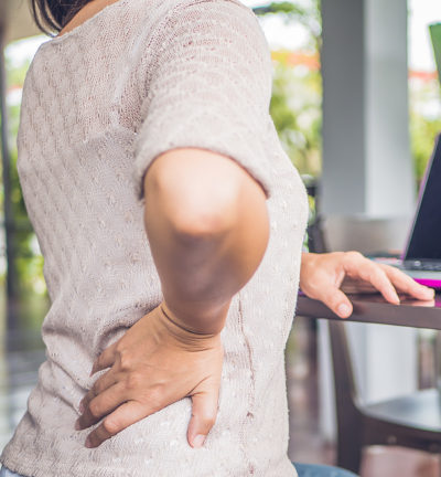 Woman with her hand on her hip suggesting hip pain